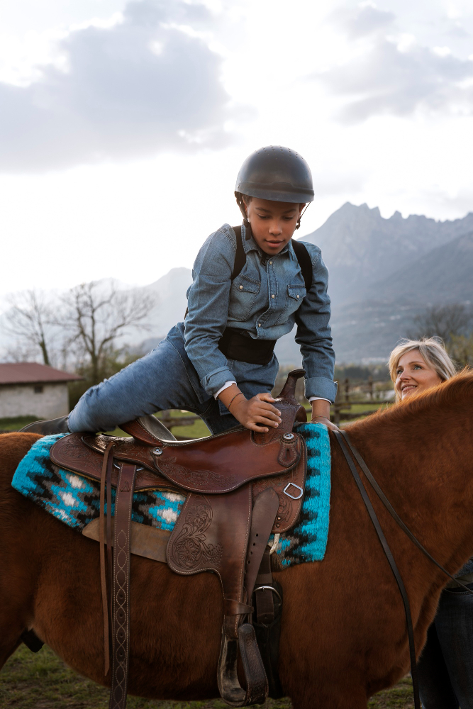 boy climbs on a horse