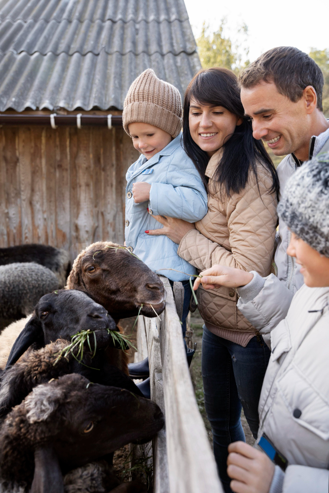parents with children petting goats